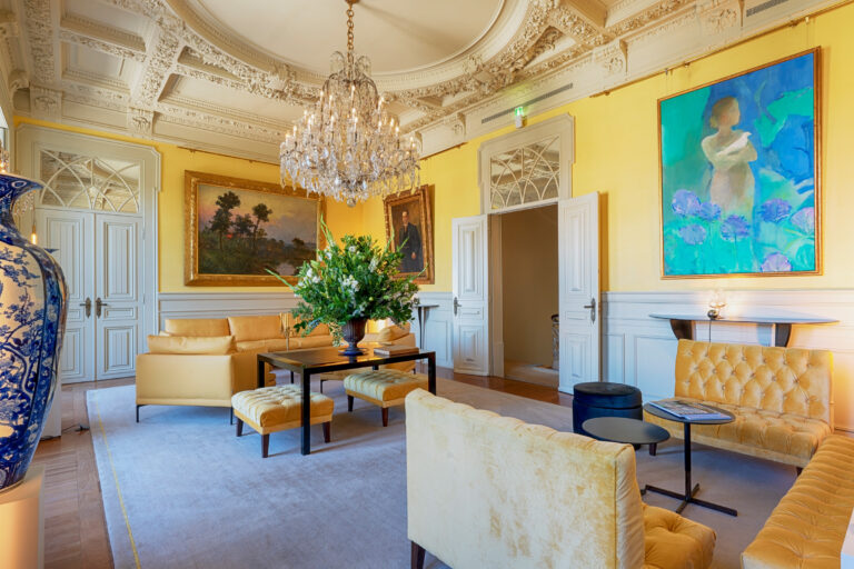 Classical palace architecture and majestic chandelier inside the Yellow Room at Verride Santa Catarina